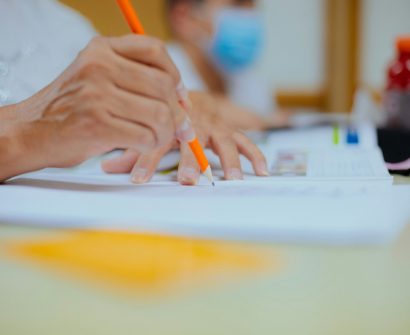 person writing on white paper